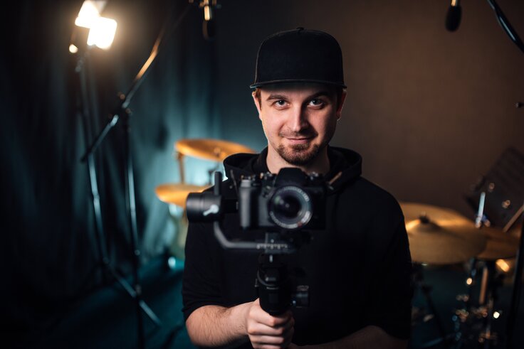 Videographer in Israel filming indoors with a gimbal.